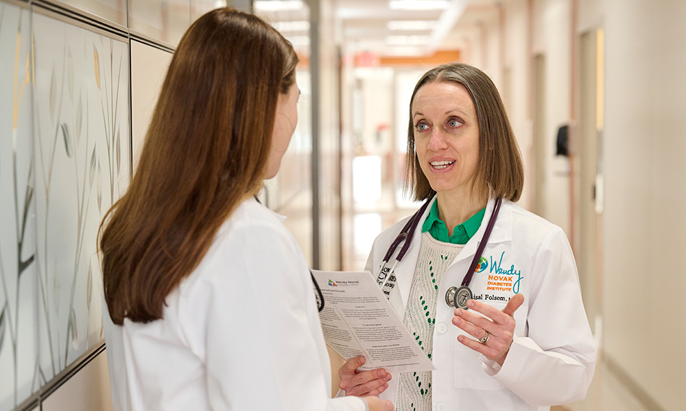 Lisal J. Folsom, M.D., M.S., discusses thyroid function tests with a colleague