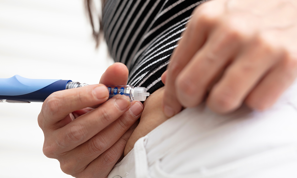 A patient administers insulin using an insulin pen.