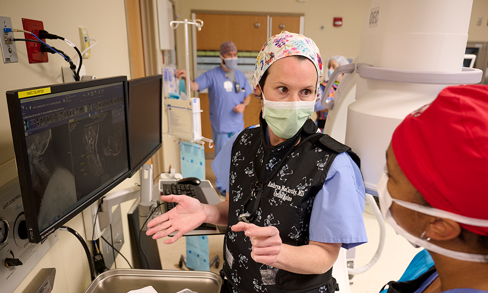Kathryn J. McCarthy Mullooly, M.D., is shown preparing for a minimally invasive spine surgery