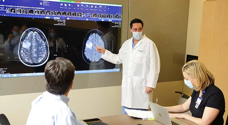 David A. Sun, M.D., Ph.D., reviews a patient’s response to a brain tumor clinical trial